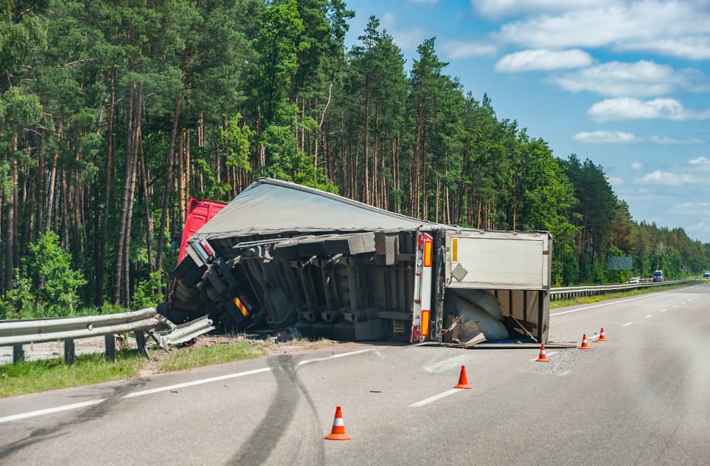 An overturned truck on the side of the road