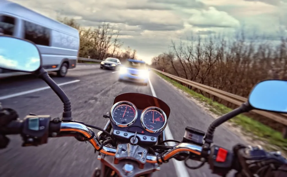 A speedy Motorcycle headed towards a car