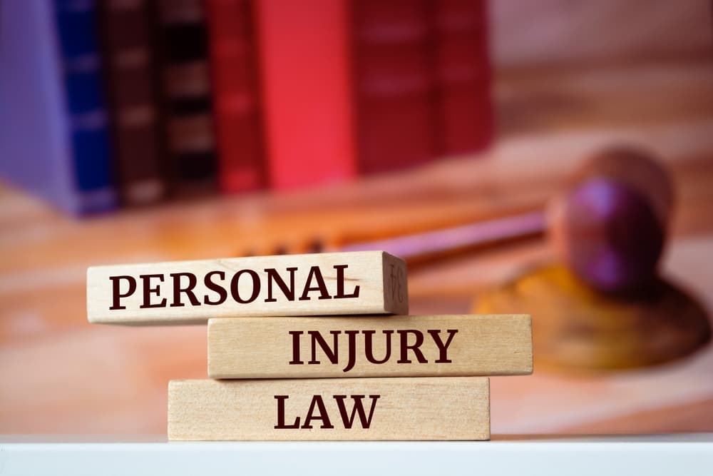 Wooden blocks with words 'Personal Injury Law'. Legal concept.