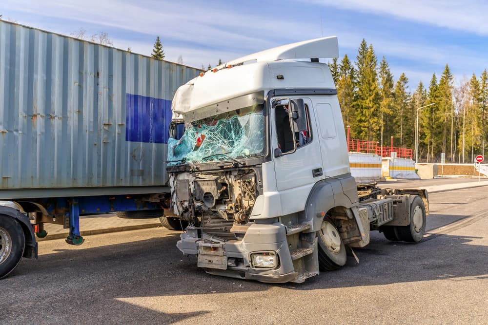 A truck damaged in an accident, showcasing the aftermath of a collision, with visible dents and wreckage, symbolizing the need for legal assistance in accident cases.