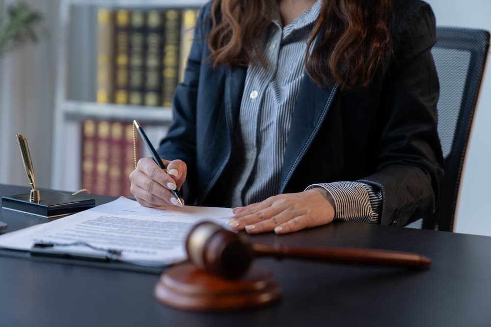 A female attorney works diligently at her desk in her office.