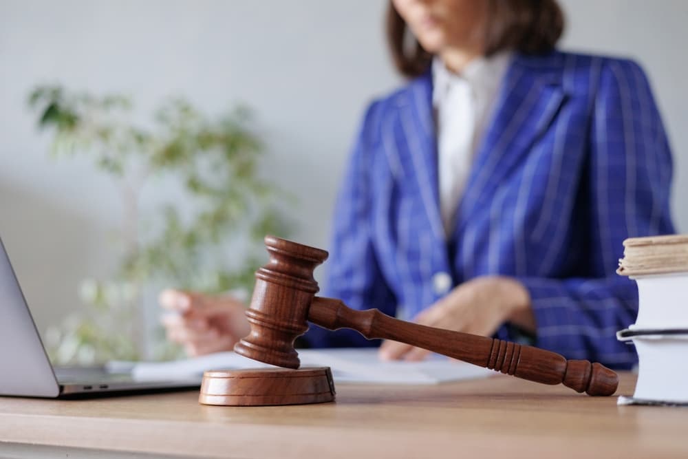 A female lawyer or judge reviews documents or a contract, handling the case and she is working in the office.