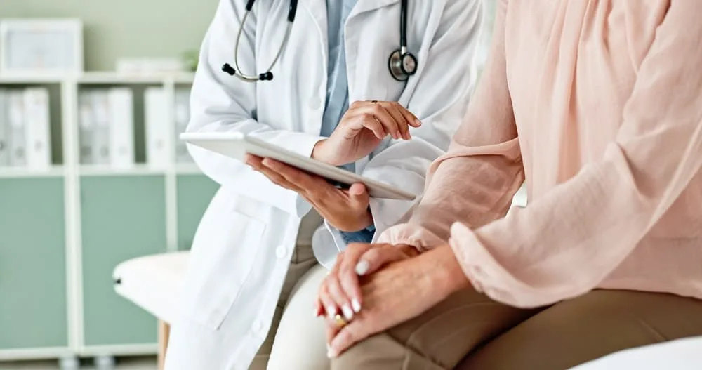 Healthcare specialist showing evidence of malpractice on tablet