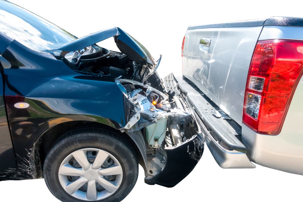 Two cars involved in a crash accident, with visible damage on both vehicles, set against a white background.