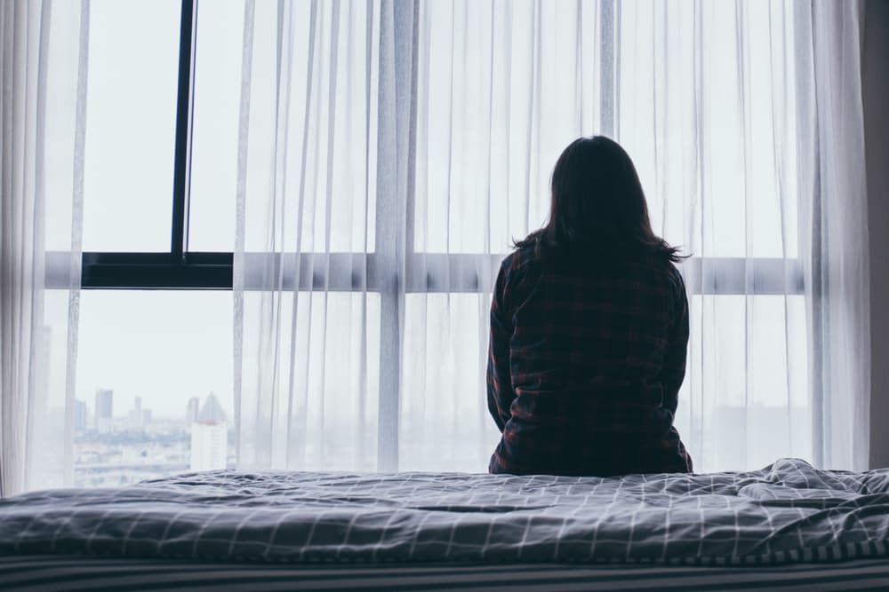 Young girl experiencing a panic attack, covering her face with her hands, feeling sad, fearful, and stressed. Depicts emotional distress and anxiety, highlighting the impact of domestic violence and mental health struggles.