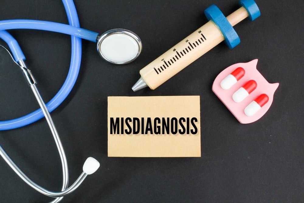 Stethoscope, needle shape and medicine with the word Misdiagnosis.