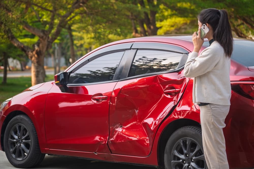 A lady calling someone after car crash
