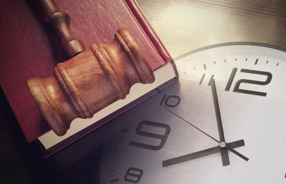 Clock, Gavel and Book on a Table