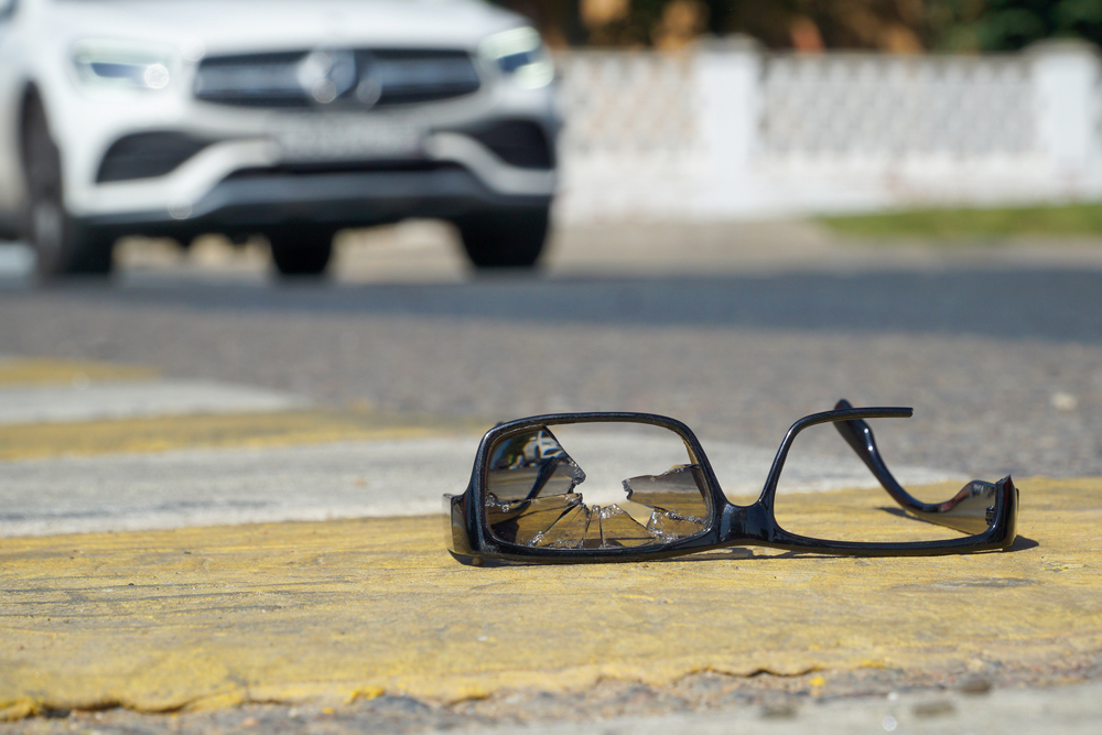 Broken eyeglasses on a roadway symbolizing evidence after a fatal accident
