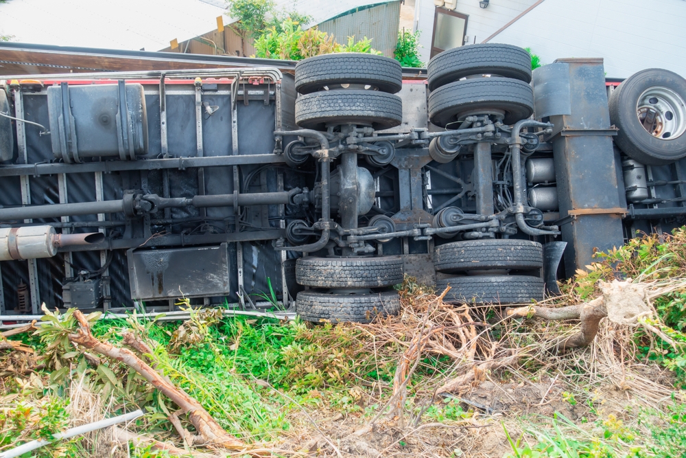 Overturned commercial truck caused by potential mechanical failure or negligent maintenance