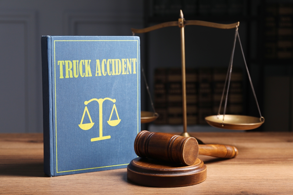 Truck accident law book and gavel representing legal liability after a commercial truck crash