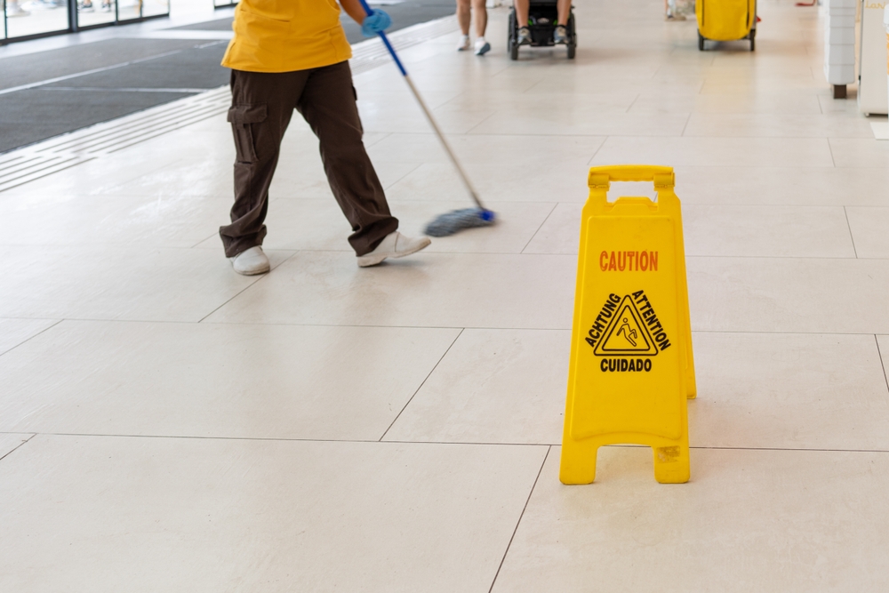 Wet floor hazard with caution sign that can lead to a slip-and-fall accident
