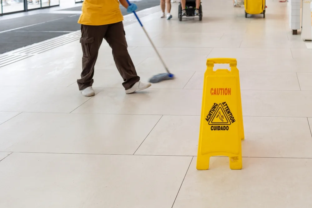 Wet floor hazard with caution sign that can lead to a slip-and-fall accident