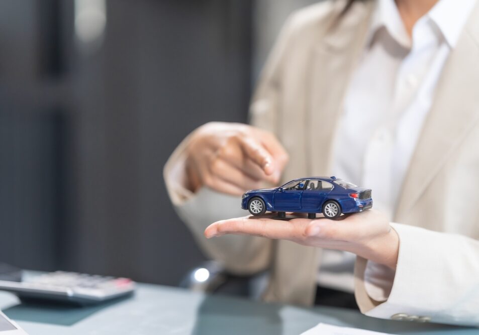 Experienced,Asian,Businesswoman,Adept,In,Car,Insurance,Processes.,Skilled,In A female car accident lawyer holding car model in hand